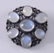 overall. 100-150. 280. An early 20th century moonstone mounted circular brooch of pierced design, 32mm diameter.
