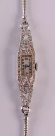 A lady s diamond mounted cocktail wristwatch, the rectangular dial with