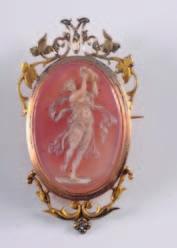 307 309 307. An oval cornelian agate and cultured seed pearl cameo brooch/pendant within a frame of scroll pierced design, 51mm overall. 700-900. 308.