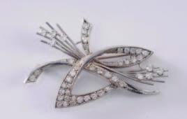 A diamond mounted ribbon and floral spray brooch with brilliant-cut and single-cut diamonds. 500-700. 348.