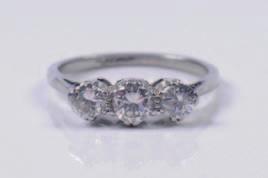 376 377 378 376. A platinum and diamond mounted three stone ring with central circular brilliantcut stone estimated to weigh 0.25cts between smaller circular diamonds each approximately 0.