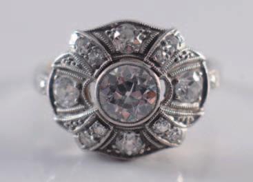 A platinum and diamond mounted single stone ring with central old brilliant-cut diamond estimated to weigh 1.5cts between baguette-cut diamond two stone shoulders. 1800-2200.