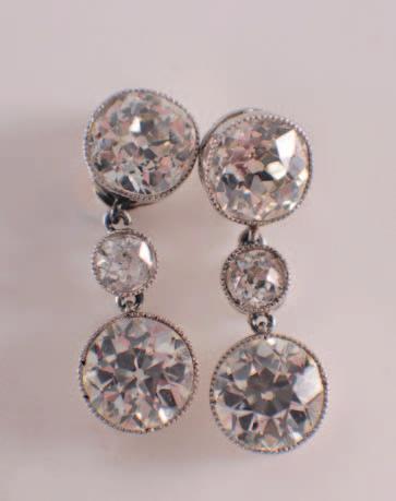 420 419 421 419. A pair of diamond three stone drop earrings each with a round old brilliantcut diamond approximately 1.0cts, suspended from a cushion shaped diamond approximately 0.