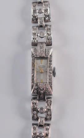 A lady s platinum and diamond mounted cocktail wristwatch, the rectangular dial with baton markers, in a