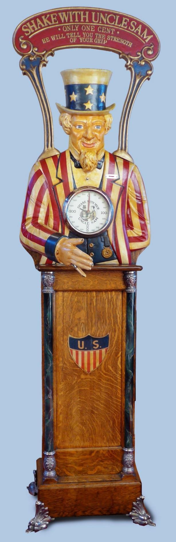 In this case, the Caille version adds a fancy top-sign promoting: Shake With Uncle Sam; Only One Cent; He Will Tell You the Strength of Your Grip.