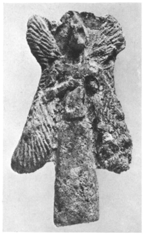 Clay figurine, (f a type buried under the floors of Assyrian houses to keep away evil spirits. ix century B.C. It represents the same figure, with wings and eagle head and holding a bucket, that appears on Assyrian reliefs standing next to the "sacred tree," as shown at the right.