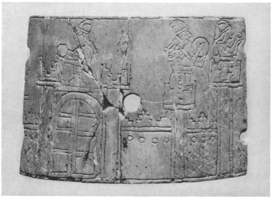 Parts of a box on which is depicted the Assyrian king in full battle array being greeted by women with cymbals on the battlements of a walled city. Assyrian, Ix-vIII century B.C.