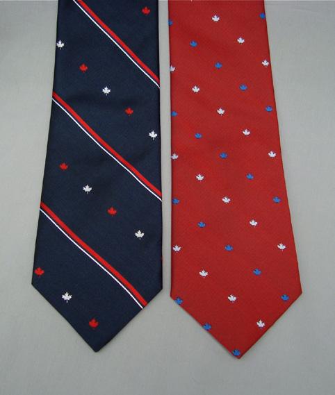 MPLE LEF MOTIF POLYESTER TIES Maple Leaf Motif Polyester Ties made in anada 0599/1 navy tie with stripe / small white and red maple leaves - 100% polyester $38.
