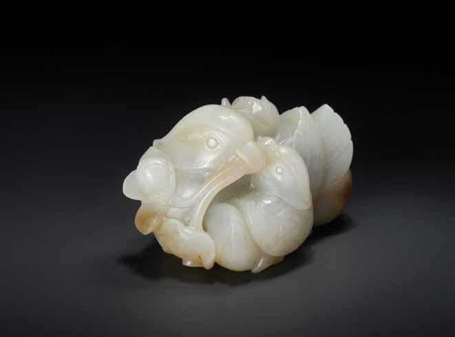 15 A QING DYNASTY CELADON AND RUSSET JADE MANDARIN DUCKS AND LOTUS GROUP Light celadon color jade with russet inclusions, smooth surface polish China, Qing Dynasty This auspicious jade group of two