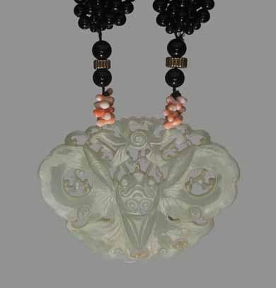 29 A PIERCED CELADON JADE BUTTERFLY PLAQUE, QING DYNASTY Celadon jade of even color, smooth surface polish Onyx and coral necklace with gilt silver clasp and ornaments (marked Sterling at the clasp)