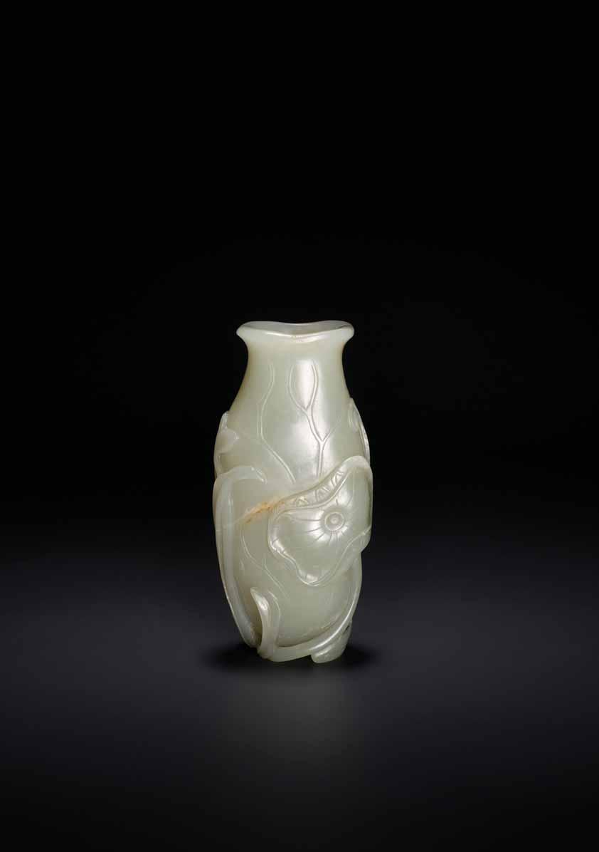 33 AN 18 TH CENTURY CELADON AND RUSSET JADE LOTUS VASE Pale celadon with sparse russet inclusions, excellent polish China, 18 th century The vase itself takes the shape of a curved lotus leaf with an