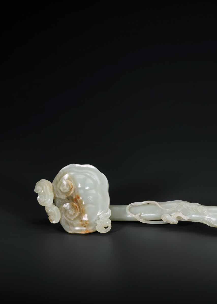36 A KANGXI PERIOD CELADON AND RUSSET JADE RUYI SCEPTER Celadon jade of even color with russet inclusions, excellent surface polish China, Kangxi period (1662 1722) Finely finished to a smooth and