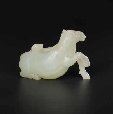 40 AN 18 TH CENTURY CELADON JADE CARVING OF A RECLINING LADY Celadon Jade of an even color with very few natural inclusions, excellent surface polish China, 18 th century 39 A PALE CELADON HORSE AND