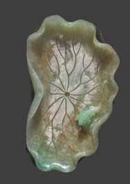 43 A JADEITE SCULPTURE OF A PHEONIX WITH PEONY, 1900s Jadeite in white, lilac, russet, and green hues with natural inclusions; good polish.