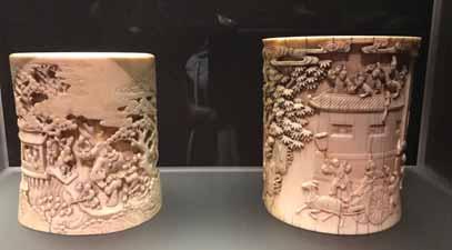 48 AN IMPERIAL 18 TH CENTURY IVORY BITONG BRUSHPOT WITH THE STORY OF PAN YUE Ivory, wooden base China, 18 th century The thick cylindrical walls superbly carved in different levels of relief with a