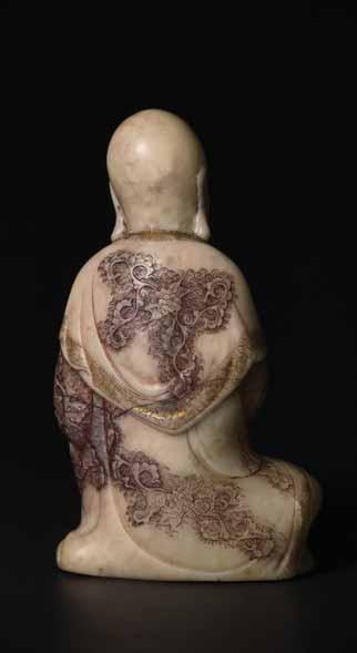 61 A MASTERLY CARVED 18 th CENTURY SOAPSTONE FIGURE OF A LUOHAN WITH QILIN Soapstone of an opaque beige -white color with natural inclusions in various other hues, remains of gold and black paint