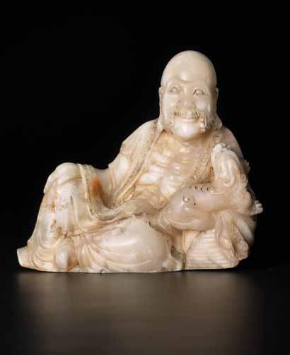 With his other hand, the holy man is holding a qilin cub, that is playfully looking up to him.