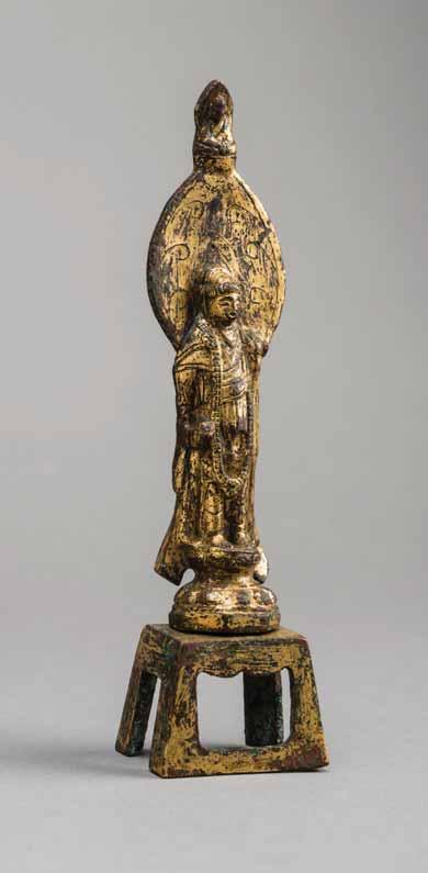 93 A GILT BRONZE VOTIVE FIGURE OF GUANYIN, NORTHERN WEI DYNASTY Fire-gilt bronze China, Northern Wei Dynasty (386 535) The Bodhisattva Guanyin cast standing against a lotus petal shaped mandorla with