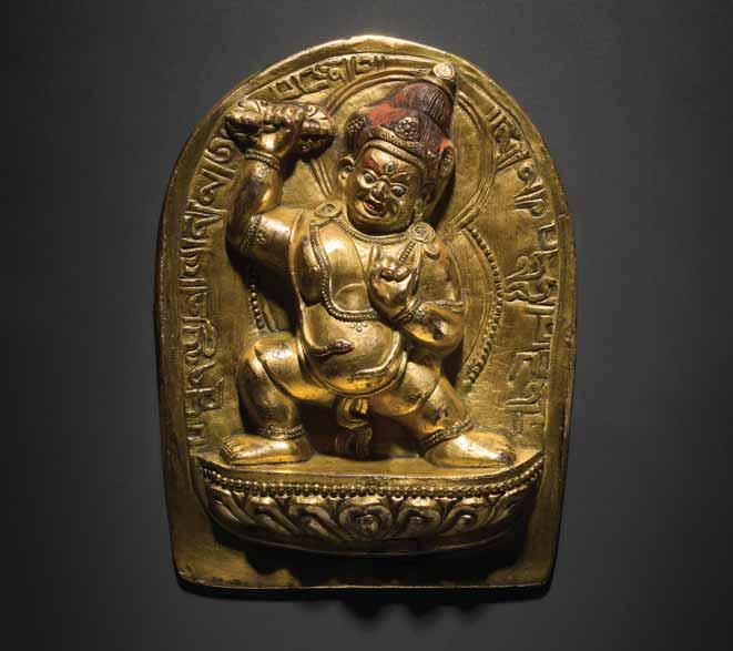95 A SMALL INSCRIBED GILT-BRONZE STELE OF MAHAKALA Cast bronze with fire-gilding, fine chiseling work and remainders of cold painting Tibetan-Chinese, 18th century The two-armed Mahakala holds a