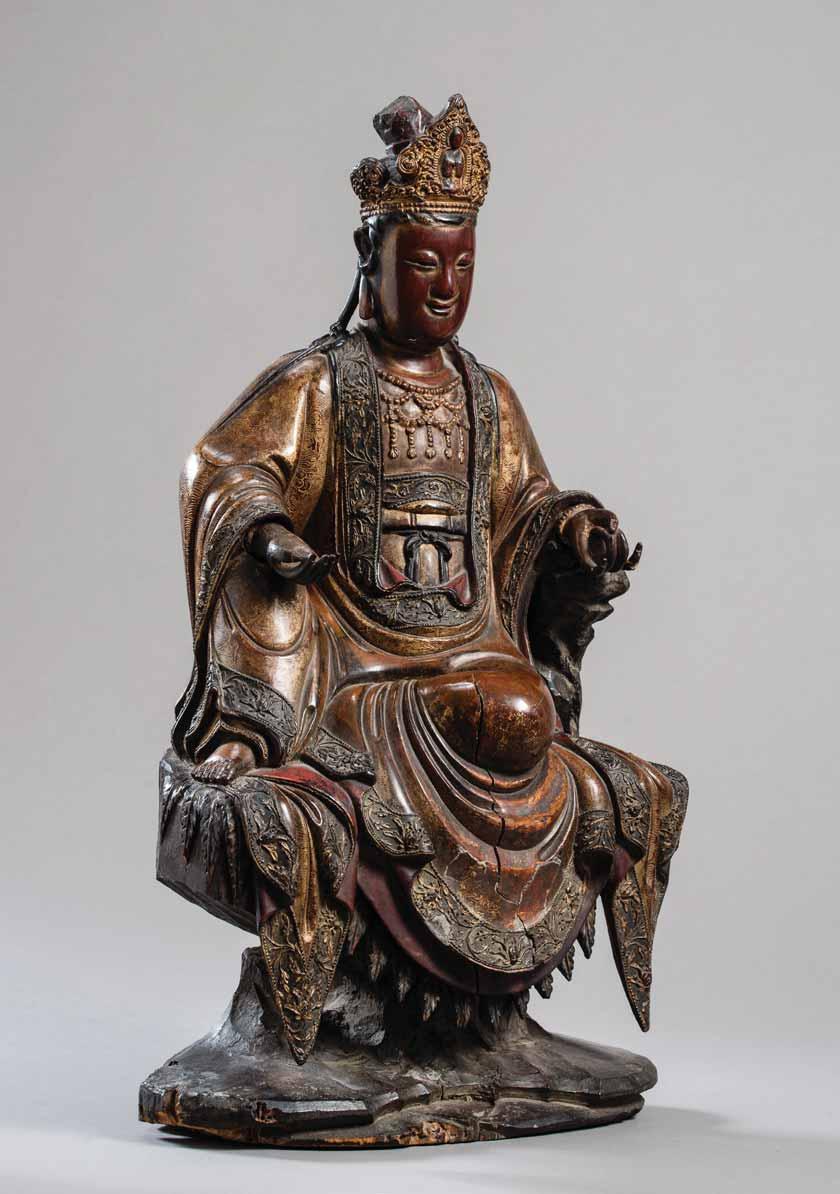 98 A LARGE AND IMPORTANT MING DYNASTY POLYCHROME-LACQUERED WOOD FIGURE OF GUANYIN Wood and lacquer China, Ming Dynasty, dated to the Dingmao year, corresponding to 1567 or 1627 The bodhisattva seated