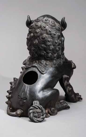 103 A MING DYNASTY BRONZE CENSER IN BUDDHIST LION SHAPE, 17 th CENTURY Bronze China, Ming Dynasty, 17 th century The guardian lion is spiritedly cast in a classical posture with his left paw resting