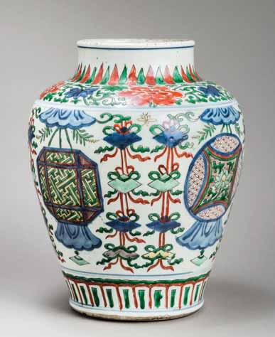 117 A TRANSITIONAL WUCAI OVIFORM VASE WITH CANOPIES AND BANNERS, 17 th CENTURY White glazed porcelain with underglaze blue decoration.