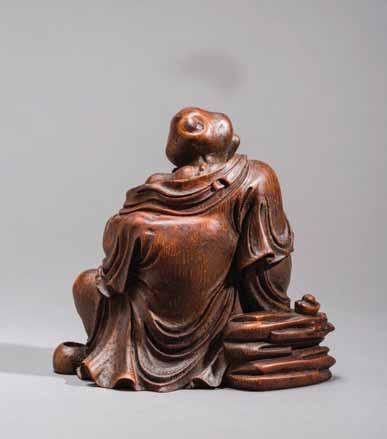 9 AN 18 TH CENTURY BAMBOO-ROOT FIGURE OF A LUOHAN WITH GOLD INGOTS Bamboo China, 18 th century This masterly carved bamboo-root figure depicts a Luohan, seated, leaning against a rock and