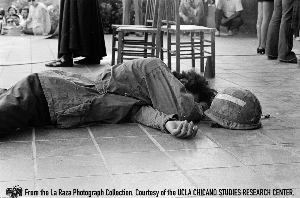 Person lying on stage during a performance at Fresno Moratorium Pedro Arias,