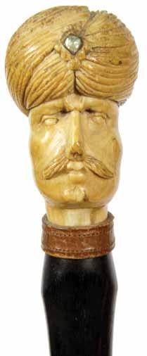 1900-A large carved gentleman with a turban incrusted with jewels, leather collar, ornately carved ebony shaft with various flowers and foliage, metal ferrule H. 3 x 3 x 2, O.L.