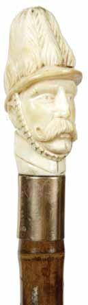 1890-Ivory soldier with handlebar mustache, collar is 14 kt rose gold and signed Brigg, bamboo shaft and metal H. 1 ¼ x 2 ¾, O.L. 39 $500-$800 80. 82. Ivory Lion Ca.