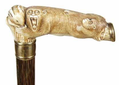 101. Carved Ivory Baboon Ca. 1890-A carved ivory Japanese handle with a baboon and its child, gold end plate and collar, stepped partridgewood shaft and a horn H. 4 ¼ x 1 3/8, O.L. 35 $800-$1,200 101.