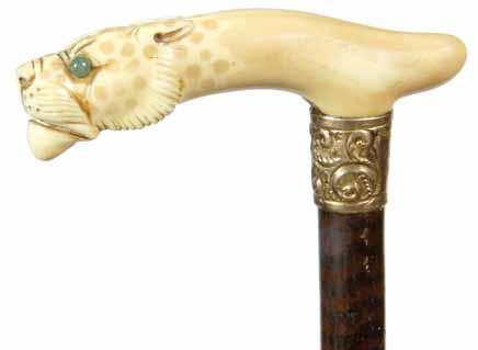 1875-A carved ivory dress cane with a Jester type figure, goldfilled fluted collar which has a small separation in the rear, exotic wood shaft and a metal