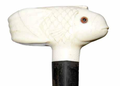 177. Ivory Fish Ca. 1890-A Japanese carved ivory fish with two color glass eyes, probably carp, silver metal collar, ebonized shaft and an ivory H. 3 ½ x 1 ¾, O.L.