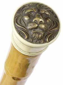 Ivory Lion Ca. 1890-A carved ivory handle with a bell bronze lion atop, thick bamboo shaft and a horn H. 1 ½ x 1 ½, O.L. 35 ½ $400-$700 206. 208.