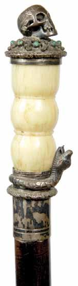 1885-A carved ivory devil with a buttocks head, flipping the cane makes a red tongue extend from the mouth, coin silver collar, malacca shaft and an iron pike H.1 ¾ x2,o.l.33 ¼ $800-$1,200 15.