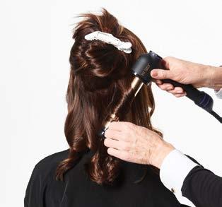 Starting in the back, using a large round brush, overdirect the hair straight out to create lift and dry the hair.