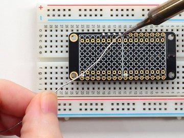 It will be easier to solder if you insert it into a breadboard - long pins down Add the