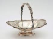 14 An Edward VII silver swinghandle basket, maker s mark rubbed, Chester, 1908, of rectangular outline with wirework cage, beaded border and reeded loop carrying handle, 24cm. wide, 19.49ozs.