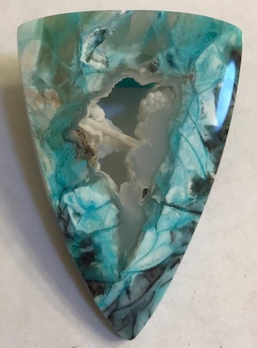 The water in that silica was very rich in dissolved copper, iron, and manganese. Those copper and manganese deposits are now found inside this blue opal!