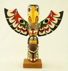 454 $75 - $100 Three small carved and painted cedar totems.