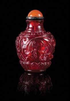 631 632 625 a red overlay Peking Glass Snuf Bottle of lattened disc form, raised on a slight oval foot, carved through the deep red overlay to the translucent, snowlake ground, each side with a