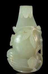 147 a carved celadon Jade Pendant depicting a dancing deity, wearing a peaked cap and lowing robes. Length 2 1/2 inches.