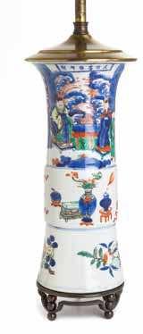 Height 6 1/2 x width 13 1/4 inches. $700-900 190 a Wucai Porcelain Beaker Vase QinG DYnastY painted to depict igures in the fenced garden, auspicious objects and lowering branches, mounted as a lamp.