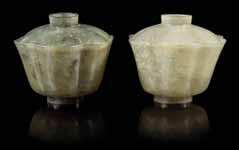 $20,000-30,000 290 a Pair of carved celadon Jade Floriform covered Bowls 19tH CEntUrY each having a lobed body, the stone with white inclusions. Height of taller 3 1/2 inches.