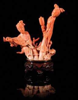 wein, Denver, Colorado $1,500-2,500 368 a Small Pink coral carving in the form of a tree trunk, raised on a itted hardwood stand. Height 2 3/4 inches.