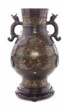 Property from a Canadian Collection $1,500-2,500 438 a massive Bronze Vase having a lobed body case with raised decoration showing birds resting on branches, lanked by a pair of elephant mask form