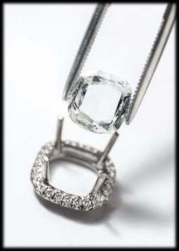 A ring sparkles with brilliant-cut diamonds and a large cushion-cut diamond of 2.3 carats* (G34HY200).