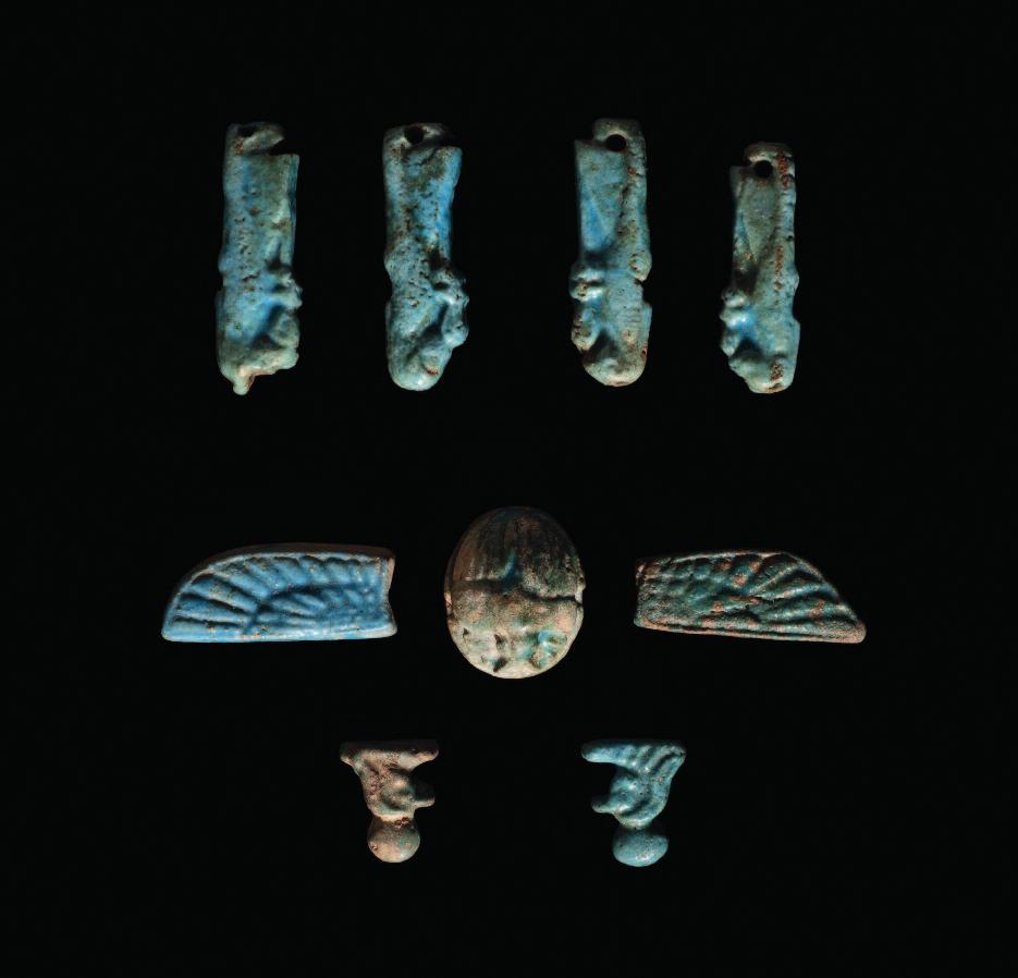 22. A complete set of Egyptian pectoral funerary amulets in faience, comprised of a winged scarab, two profile busts of the falcon-headed Horus wearing sun disc, and the four animal-headed sons of