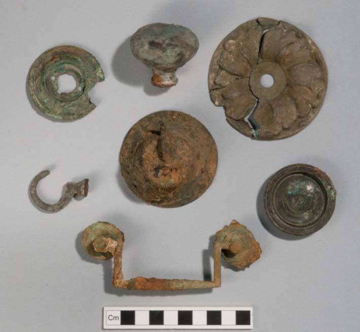 287 Figure 5.26: Selection of household fittings from Area C. Front: handle 7567/#84902. Middle left: hook 7444/#82285. Centre: bell 7567/#82256. Middle right: brass plug 7444/#82213.