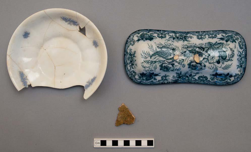 316 Figure 5.47: Ceramics in cesspit 7419 (fill 7445). The sprigged bone china saucer is on the left (#73895) and the green flow semi-vitreous fine earthenware toiletry box is on the right (#73896).